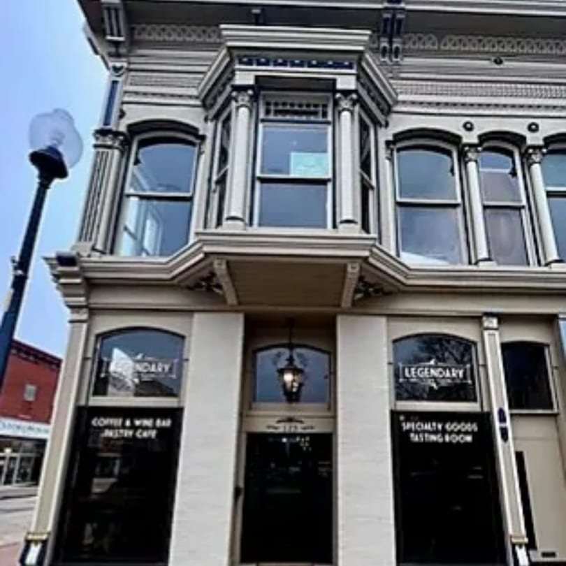 The historic Legendary Coffee & Wine Bar building with a bay window and ornate details.